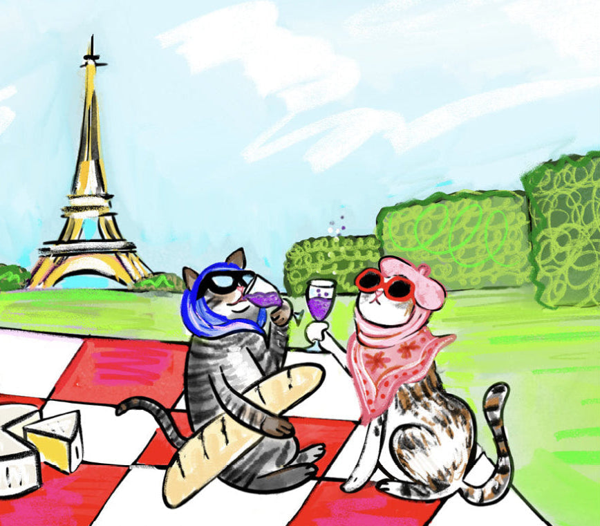 Two cats enjoying a picnic with the Eiffel Tower in the background